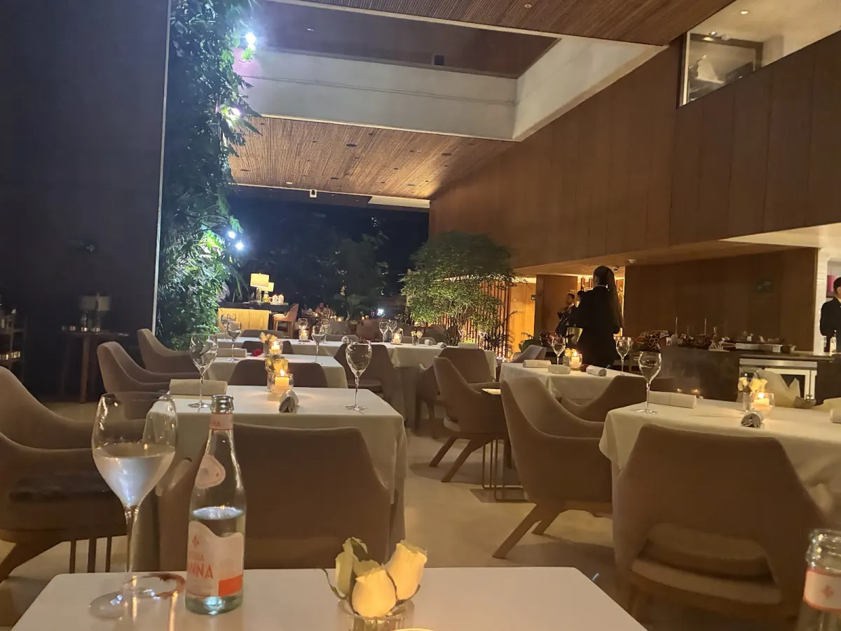 The dining room at Elcielo Medellín in the evening, with low lighting over the tables