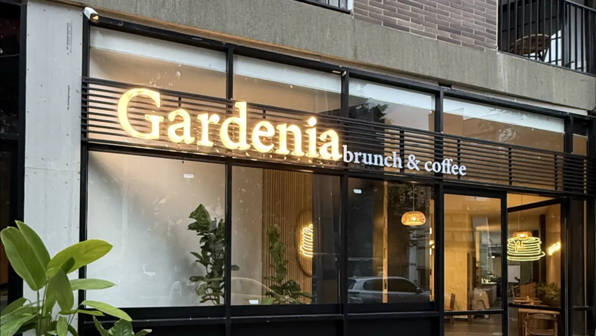 The front of Gardenia Brunch & Coffee with its illuminated sign