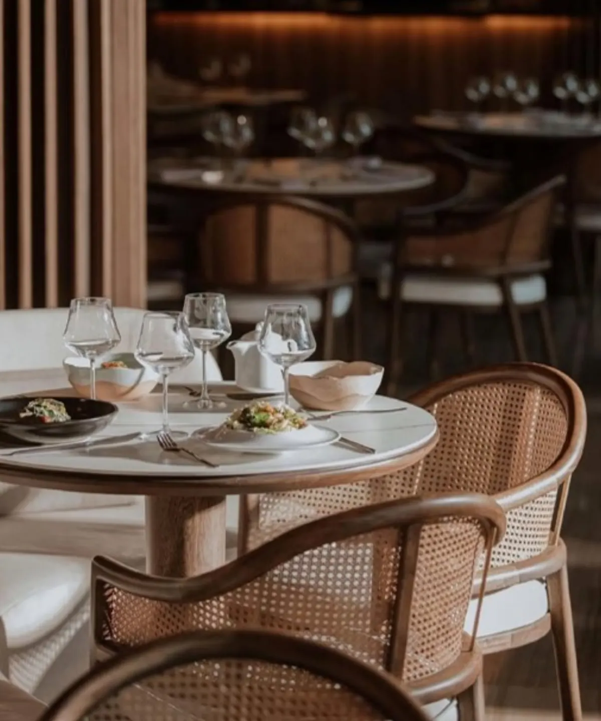 Dining tables with rattan chairs at La Makha